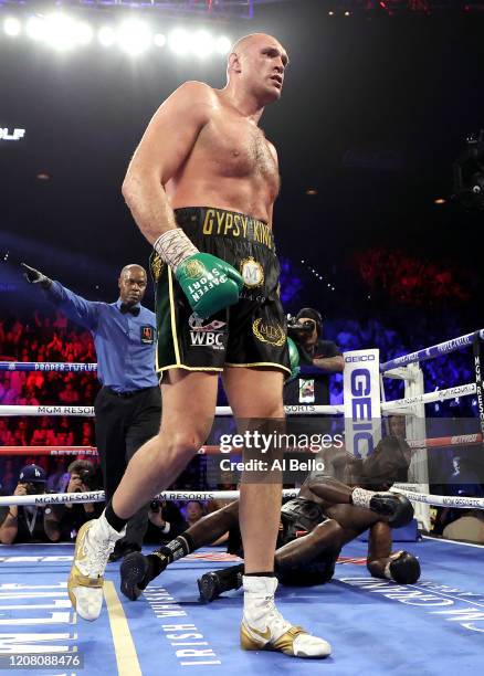 Tyson Fury knocks down Deontay Wilder in the fifth round during their Heavyweight bout for Wilder's WBC and Fury's lineal heavyweight title on...