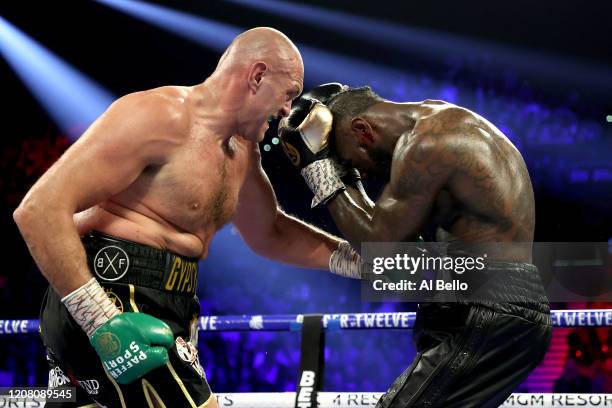 Tyson Fury knocks down Deontay Wilder in the fifth round during their Heavyweight bout for Wilder's WBC and Fury's lineal heavyweight title on...