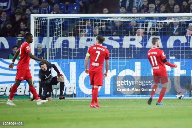 Goalkeeper Alexander Nuebel of Schalke reacts as Timo Werner of Leipzig celebrates his team's second goal during the Bundesliga match between FC...