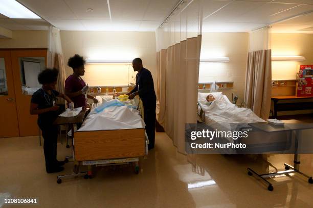 Student nurses Chukwuka Asakwe, Nazarine Beweh and Nicole Obisie attend to a Patient CareManikin in a training simulation at an education lab of the...