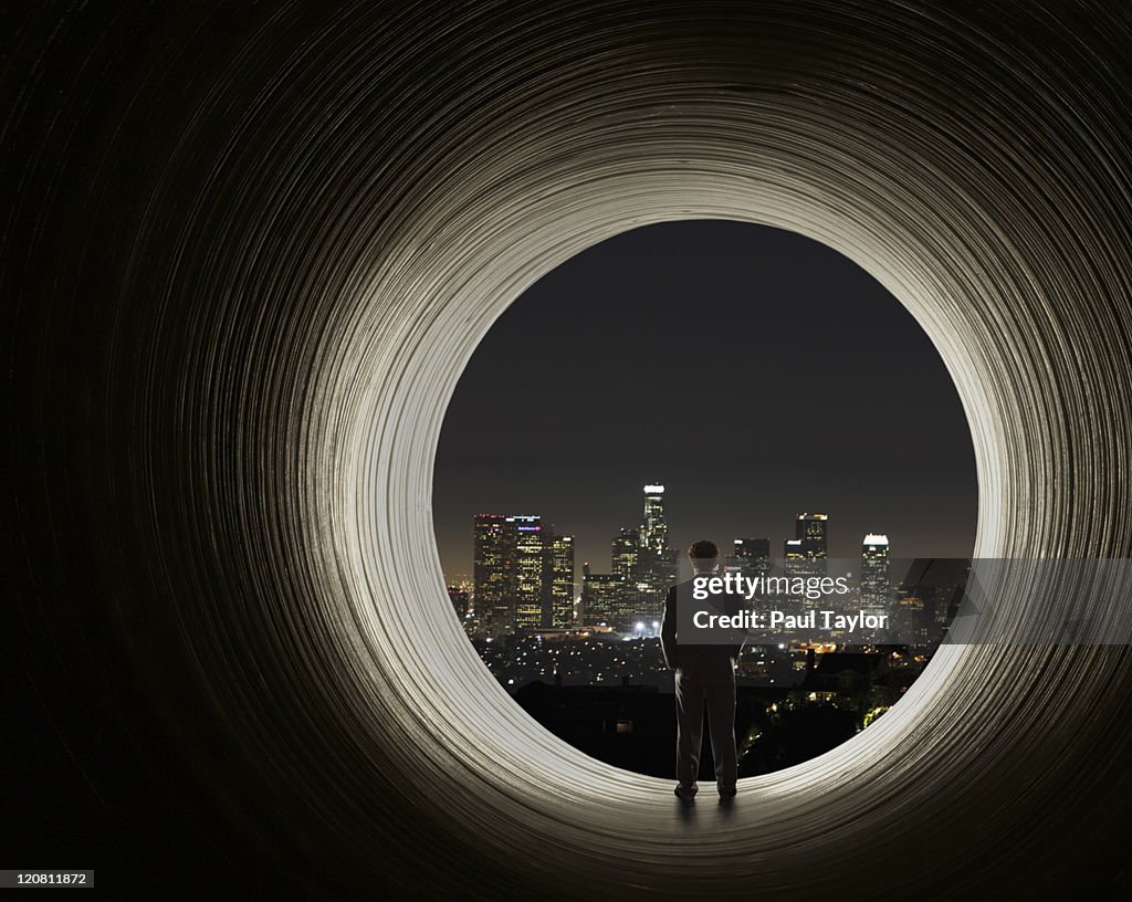 Man Viewing City from Tunnel