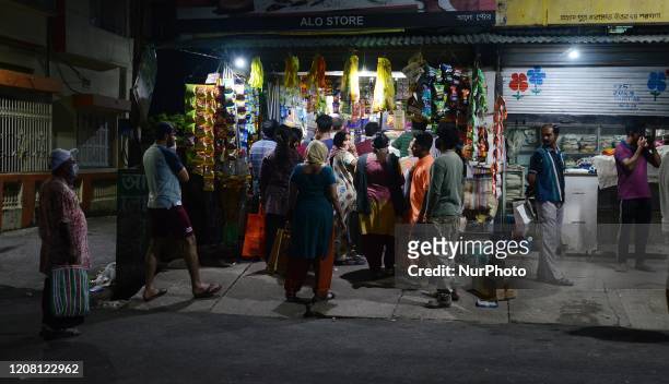 People gathered in a grocery shop for buying essential commodities following the central governments announcement of nationwide 21 day lockdown in...