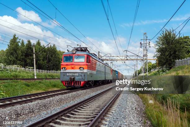 powerful electric locomotive with short container train - railing stock pictures, royalty-free photos & images