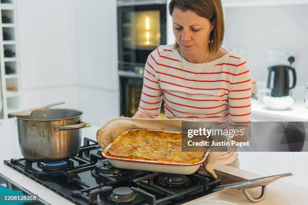 woman with her homemade lasagne - ready to eat! - lasagna stockfoto's en -beelden