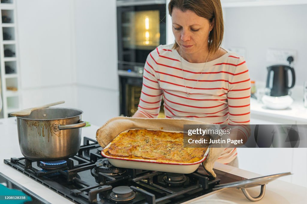 Woman with her homemade lasagne - ready to eat!