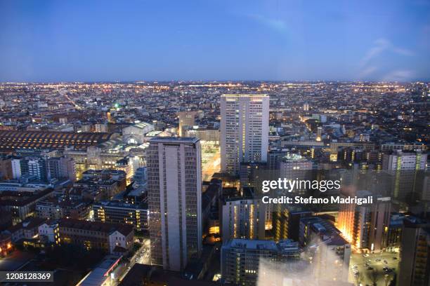 night top view of illuminated buildings and skyscrapers in modern city center offices skyscraper - milan aerial stock pictures, royalty-free photos & images