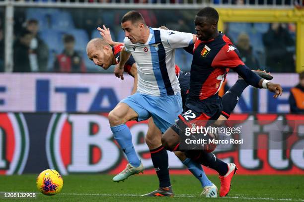 Adam Marusic of SS Lazio competes for the ball with Adama Soumaoro and Andrea Masiello of Genoa CFC during the Serie A match between Genoa CFC and SS...