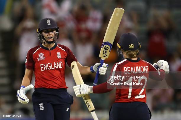 Natalie Sciver of England celebrates her half century with Tamsin Beaumont during the ICC Women's T20 Cricket World Cup match between England and...