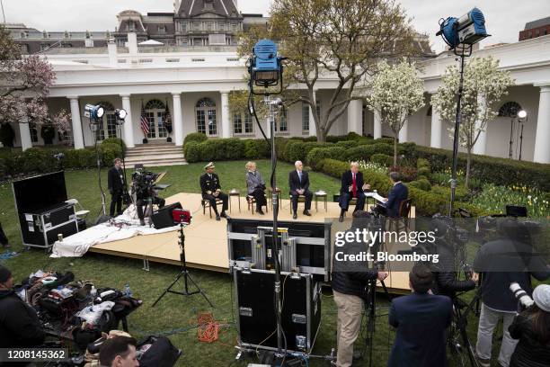 President Donald Trump, second right, and U.S. Vice President Mike Pence, third right, participate in a Fox News virtual town hall in the Rose Garden...