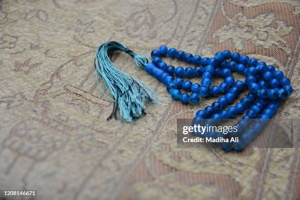 blue colored muslim tasbih / tasbeeh prayer beads, used in islam to remember allah - prayer beads stock pictures, royalty-free photos & images