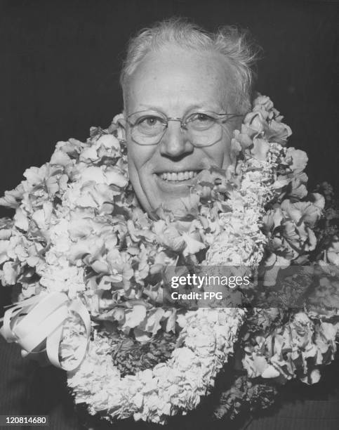 Governor of California Earl Warren wearing a lei on his arrival in Honolulu, Hawaii, 1952.