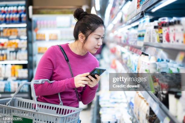 asian female shopping in supermarket - calcio sport imagens e fotografias de stock