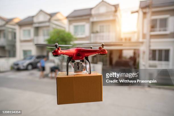 editorial on 23 february 2020, bangkok, thailand delivery drone flying in new york city - クワッドコプター ストックフォトと画像