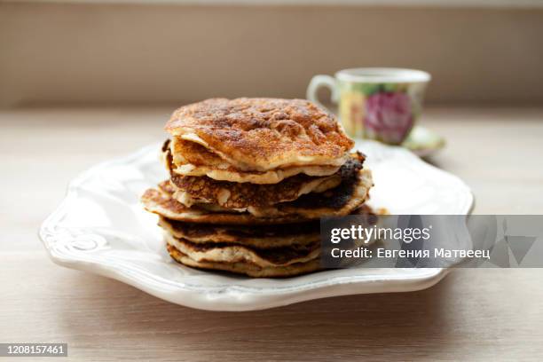 low carb keto diet pancakes from almond coconut flour stack on white plate and cup of cocoa - suikervrij stockfoto's en -beelden