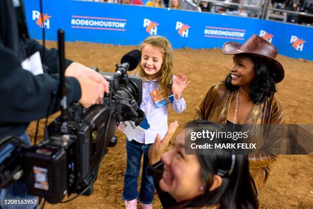 Mutton Bustin' champion Madison Wiener waves to the crowd after winning the competition during the Houston Livestock Show and Rodeo on March 6, 2020...