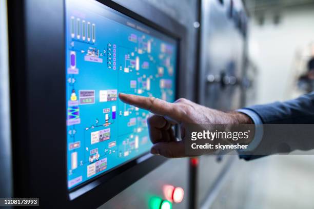 close up of an inspector working on touch screen of production machine. - computer aided manufacturing stock pictures, royalty-free photos & images
