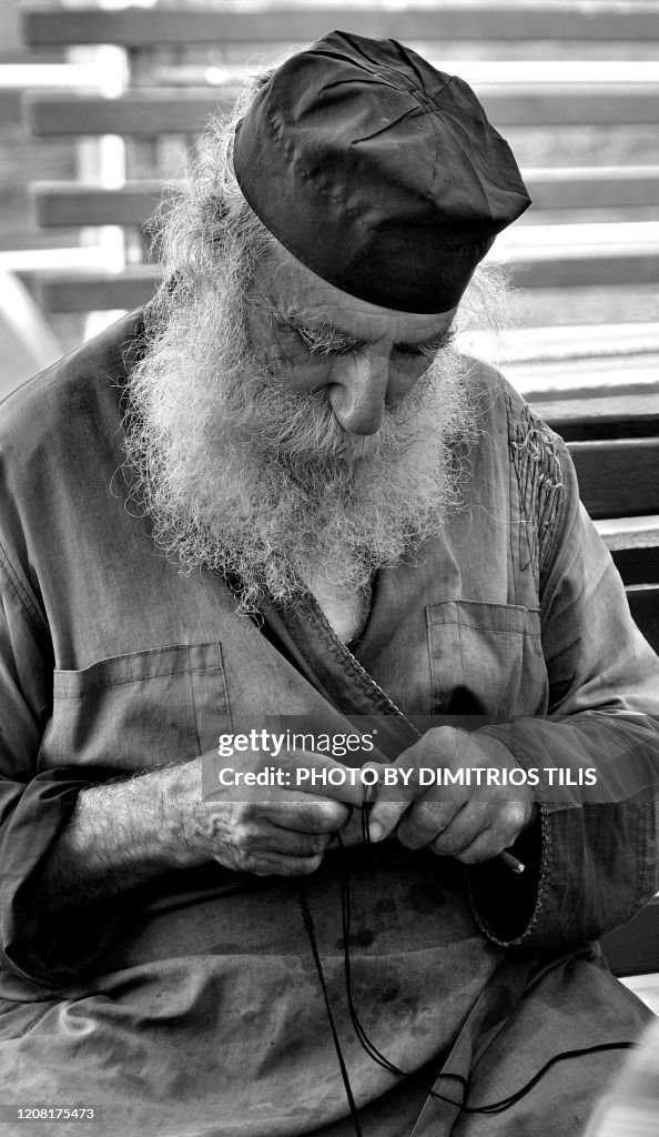 Monk knitting a prayer