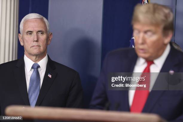 Vice President Mike Pence, left, listens as President Donald Trump speaks during a Coronavirus Task Force news conference in the briefing room of the...
