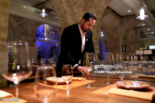 January 30: Adar Bershadsky, head of wine and sommelier at The Jaffa Hotel, prepares for service at the hotel's Don Camillo restaurant, regarded as...