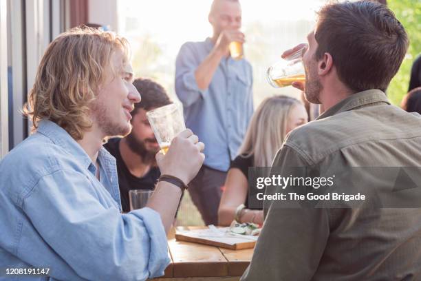 male friends having discussion at bar - pub mates stock-fotos und bilder