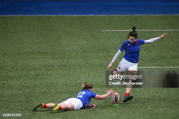 France player Jessy Tremouliere kicks a conversion as Morgane Peyronnet assists during the Women's Six Nations match between Wales and France at...