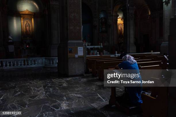 Woman sits in a church downtown during phase two of contingency measures to avoid the spread of COVID-19 on March 24, 2020 in Mexico City, Mexico....