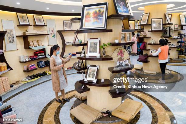 March 23, 2020 . Customers select products of Rongchang Grass Linen, also called Rongchang Xiabu, at a store in Rongchang District of Chongqing,...