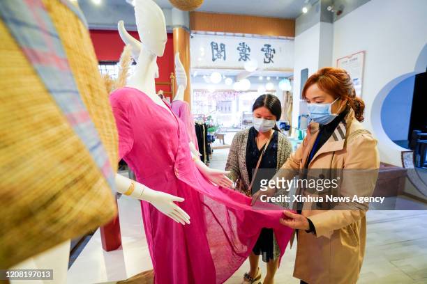 March 23, 2020 . Customers select products of Rongchang Grass Linen, also called Rongchang Xiabu, at a store in Rongchang District of Chongqing,...