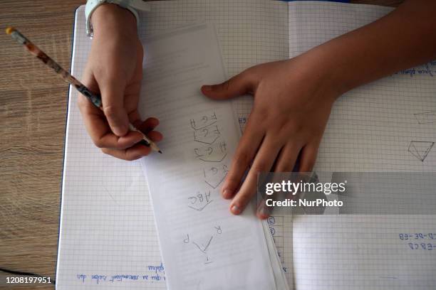 Pupil does maths on a notebook. For the 7th day, French people are on lockdown. Schools, highschools, universities are closed since March 13th....