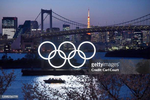 Boat sails past the Tokyo 2020 Olympic Rings on March 25, 2020 in Tokyo, Japan. Following yesterdays announcement that the Tokyo 2020 Olympics will...