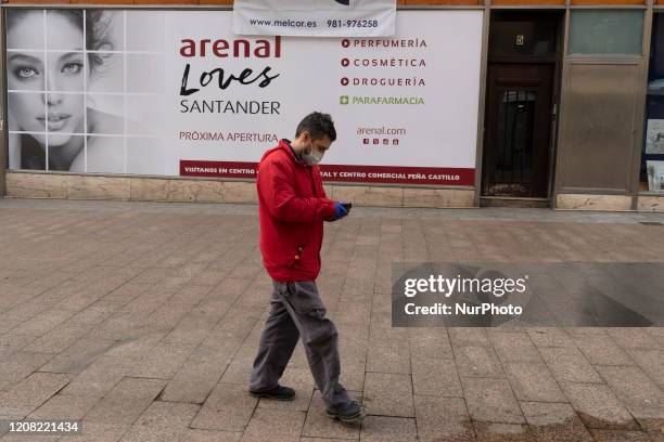 Man protected by a mask through empty streets during the mandatory government-ordered quarantine of the coronavirus in Santander