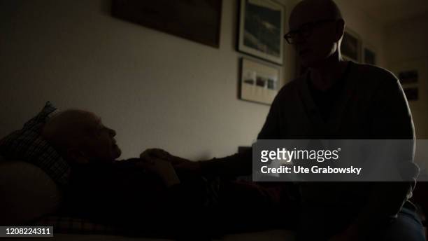 Heidelberg, Germany In this photo illustration a man is sitting at an old person's bedside on February 14, 2020 in Heidelberg, Germany.