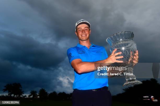 Viktor Hovland of Norway poses with the trophy on the 18th green after winning the Puerto Rico Open at Grand Reserve Country Club on February 23,...