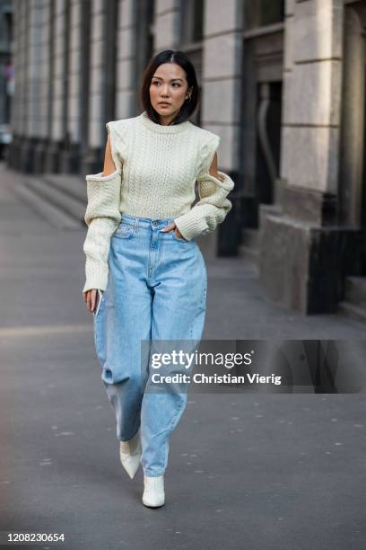 Yoyo Cao is seen wearing denim wide leg jeans, ripped jumper outside Philosophy during Milan Fashion Week Fall/Winter 2020-2021 on February 22, 2020...