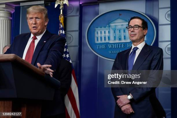 President Donald Trump, joined by Secretary of the Treasury Steven Mnuchin, speaks during a briefing on the coronavirus pandemic, in the press...