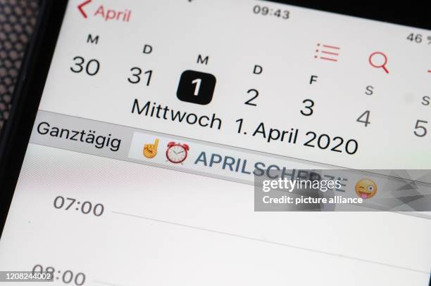 March 2020, Berlin: On the display of a smartphone, warning emojis and the note "April Fools' Day" are stored in the calendar on April 1st. Photo:...