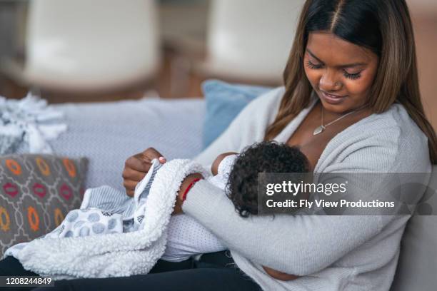woman nursing baby at home - indian mother feeding baby stock pictures, royalty-free photos & images