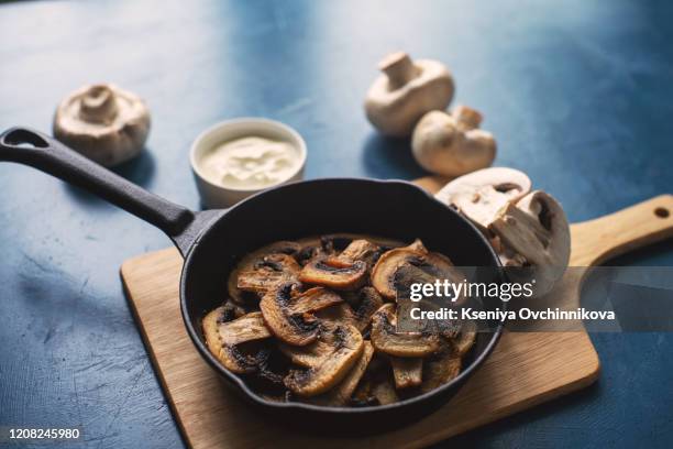 fried mushrooms in a vintage pan with fresh herbs - saute stock pictures, royalty-free photos & images