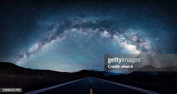 the road under the milky way arch bridge - high dynamic range imaging stock-fotos und bilder