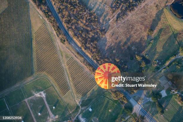 hot air balloon over road - hot air balloon from above stock pictures, royalty-free photos & images