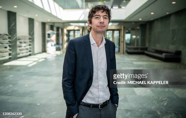 Christian Drosten, director of the Institute of Virology at Berlin's Charite hospital, poses after a press conference in Berlin on March 26 to...