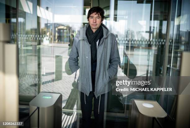 Christian Drosten, director of the Institute of Virology at Berlin's Charite hospital, leaves after a press conference in Berlin on March 26 to...