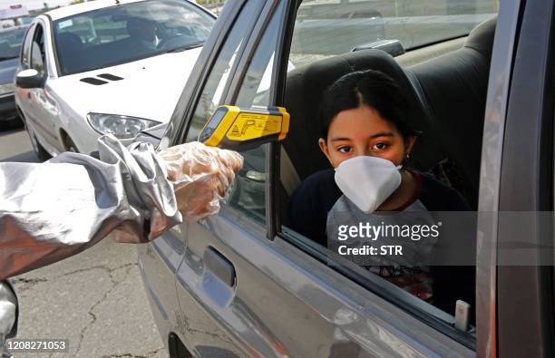 Members of the Iranian Red Crescent test people for coronavirus Covid-19 symptoms, as police blocked Tehran to Alborz highway to check every car...
