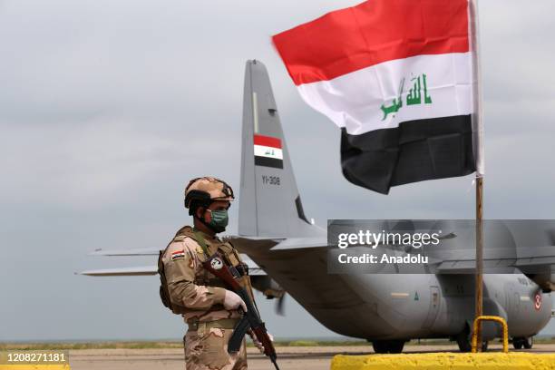 Soldier stands guard as the U.S.-led coalition against the Daesh/ISIS terror group on Thursday formally handed over to Iraq the Qayyarah airbase in...