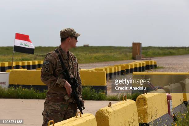 Soldier stands guard as the U.S.-led coalition against the Daesh/ISIS terror group on Thursday formally handed over to Iraq the Qayyarah airbase in...
