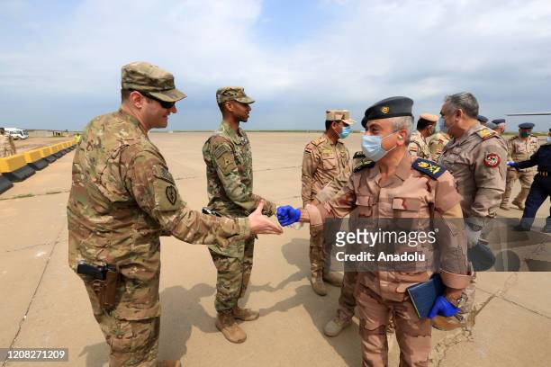 Soldiers are seen with face masks as the U.S.-led coalition against the Daesh/ISIS terror group on Thursday formally handed over to Iraq the Qayyarah...