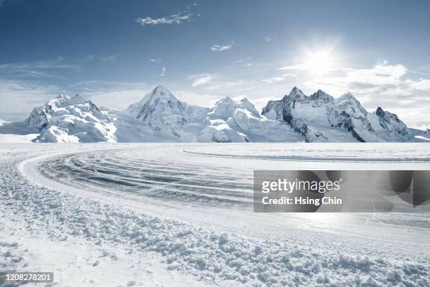snow mountain road in switzerland - snow road stock-fotos und bilder