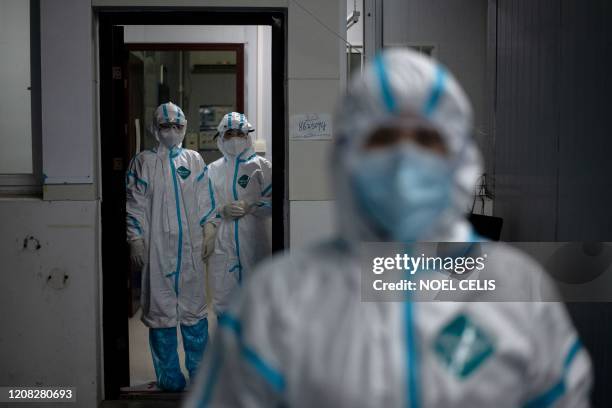 Medical workers wearing hazmat suits as a preventive measure against the COVID-19 coronavirus are seen at a fever clinic in Huanggang Zhongxin...