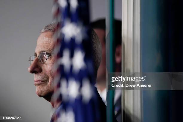 National Institute of Allergy and Infectious Diseases Director Anthony Fauci listens as U.S. President Donald Trump speaks during a briefing on the...