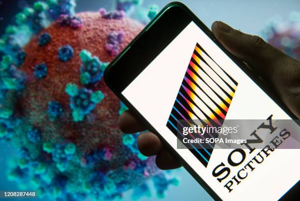 In this photo illustration the American film studio, production and film distributor company Sony Pictures logo seen displayed on a smartphone with a...